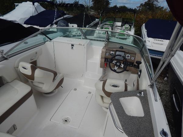 Slide: The Image of 2013 Chaparral 225 SSi boat interior with seating, steering wheel, and dashboard. - 45