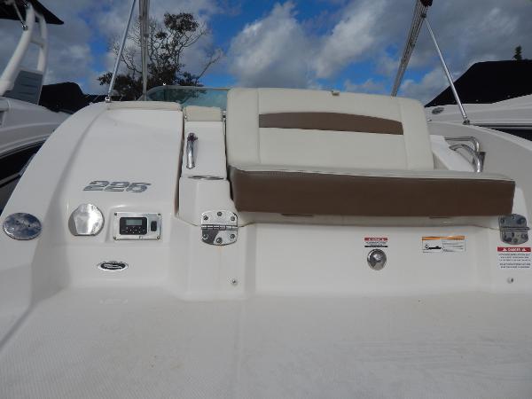 Slide: The Image of 2013 Chaparral 225 SSi boat rear seating and deck area under a blue sky. - 8