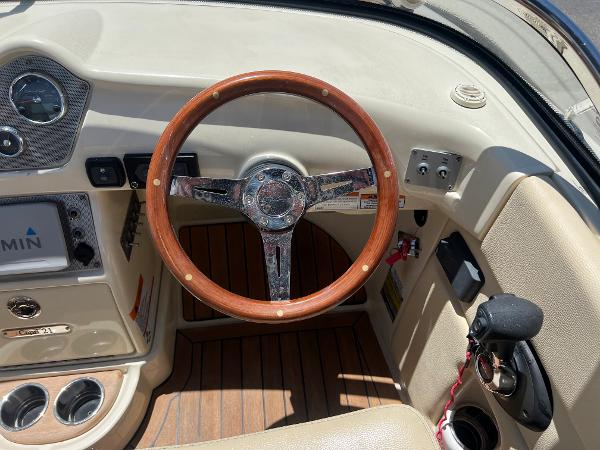 Slide: The Image of 2020 Chris-Craft Capri 21 boat dashboard with wooden steering wheel and Garmin navigation. - 11