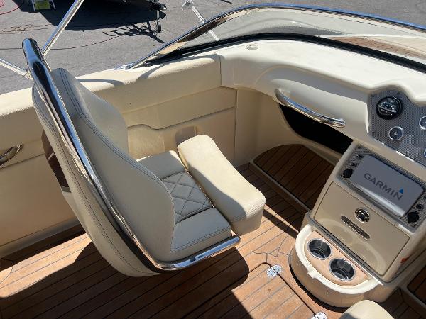 Slide: The Image of 2020 Chris-Craft Capri 21 boat interior with beige seating and Garmin navigation system. - 14