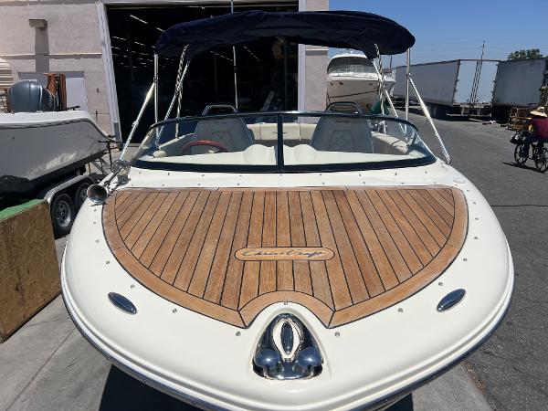 Slide: The Image of 2020 Chris-Craft Capri 21 boat with wooden deck and canopy. - 5