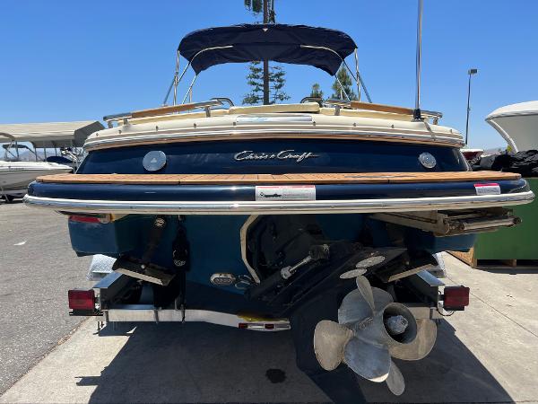 Slide: The Image of 2020 Chris-Craft Capri 21 boat rear view with propeller and canopy. - 7