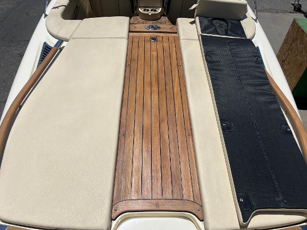 Slide: The Image of 2020 Chris-Craft Capri 21 boat with teak deck and beige upholstery. - 9