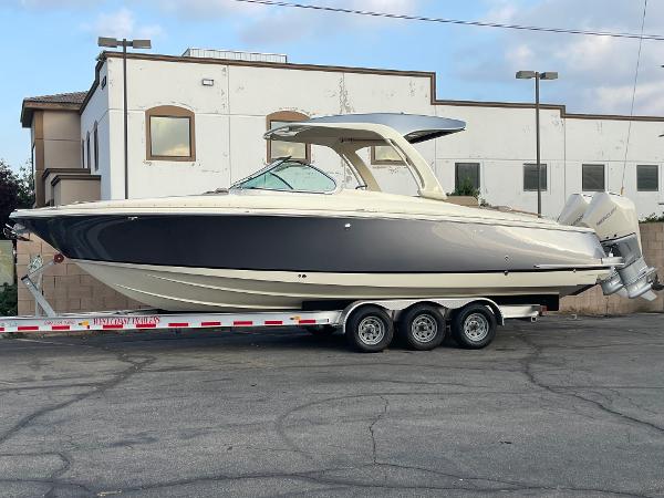 Slide: The Image of 2024 Chris-Craft Launch 31 GT boat on trailer, parked outdoors. - 0
