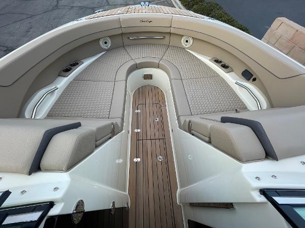 Slide: The Image of 2024 Chris-Craft Launch 31 GT boat interior with luxurious seating and teak flooring. - 11