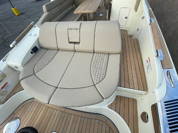 Slide: The Image of 2024 Chris-Craft Launch 31 GT boat interior with beige seating and wooden deck. - 3