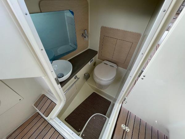 Slide: The Image of 2024 Chris-Craft Launch 31 GT boat bathroom interior with sink and toilet. - 33