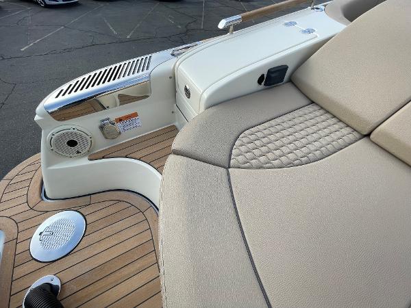 Slide: The Image of 2024 Chris-Craft Launch 31 GT boat interior with beige seating and teak flooring. - 4