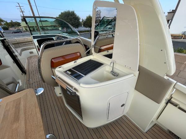 Slide: The Image of 2024 Chris-Craft Launch 31 GT boat interior with sink and seating area. - 6