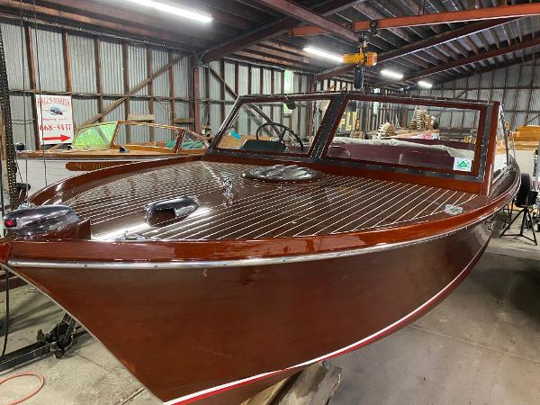 Slide: The Image of 1959 Chris-Craft Sportsman boat in a warehouse, polished wooden finish. - 1