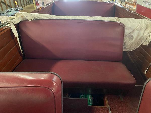 Slide: The Image of 1959 Chris-Craft Sportsman boat interior with maroon seats and wooden paneling. - 14