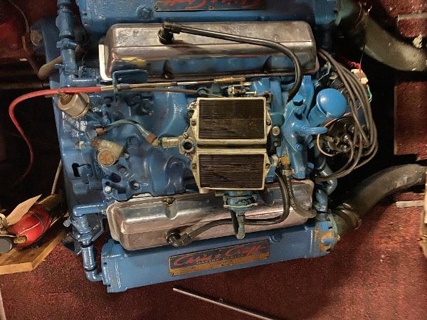 Slide: The Image of 1959 Chris-Craft Sportsman engine, blue with chrome details, in a boat's engine compartment. - 15