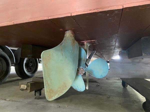 Slide: The Image of 1959 Chris-Craft Sportsman boat propeller and rudder in a garage. - 18