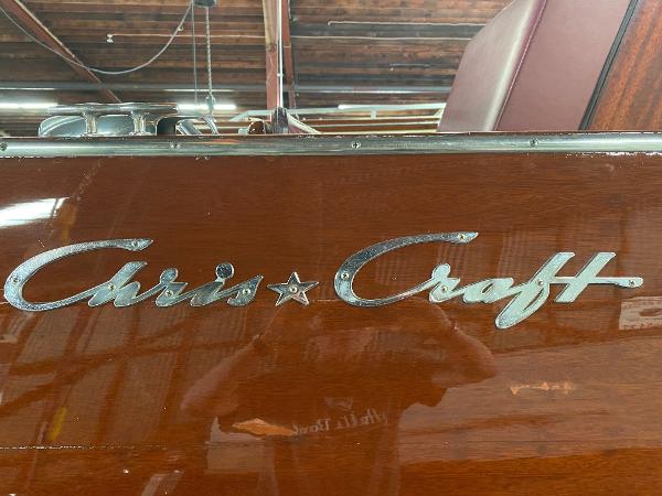 Slide: The Image of 1959 Chris-Craft Sportsman boat with classic wooden finish and logo. - 19