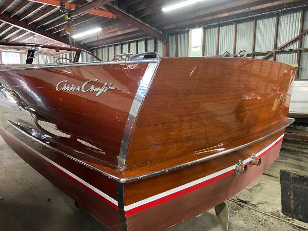 Slide: The Image of 1959 Chris-Craft Sportsman wooden boat in a storage facility. - 4