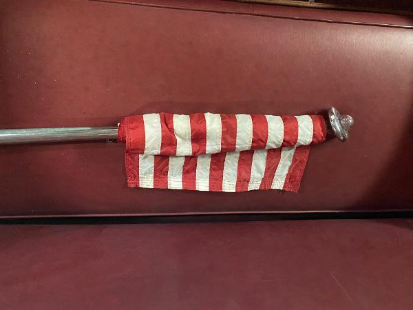 Slide: The Image of 1959 Chris-Craft Sportsman boat with a folded American flag on red upholstery. - 6