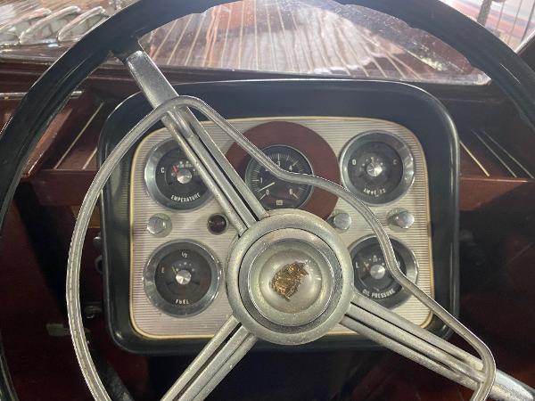 Slide: The Image of 1959 Chris-Craft Sportsman dashboard with vintage gauges and steering wheel. - 7