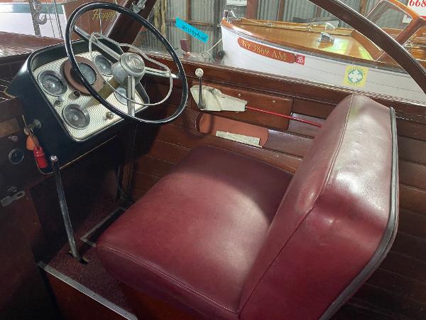 Slide: The Image of 1959 Chris-Craft Sportsman boat interior with red leather seat and vintage steering wheel. - 8
