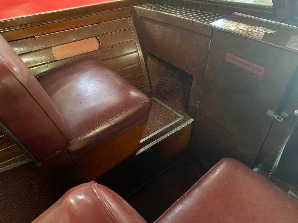 Slide: The Image of 1959 Chris-Craft Sportsman interior with red leather seats and wooden paneling. - 9