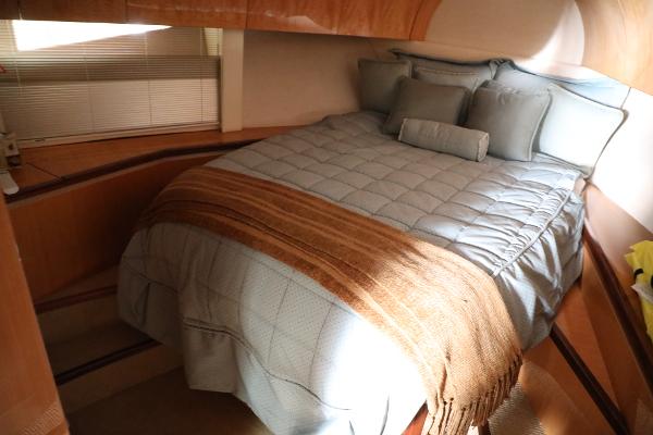 Slide: The Image of 2008 Cobalt 46 yacht bedroom with cozy bedding and wooden interior. - 25