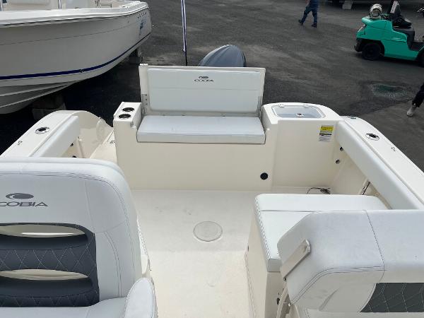 Slide: The Image of 2024 Cobia 220 Dual Console boat interior with seating and storage. - 3