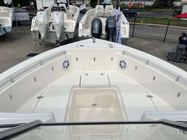 Slide: The Image of 2024 Cobia 220 Dual Console boat interior with seating and storage compartments. - 7
