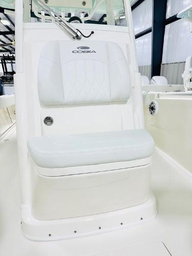 Slide: The Image of 2024 Cobia 262 CC boat interior with white seating and console. - 8