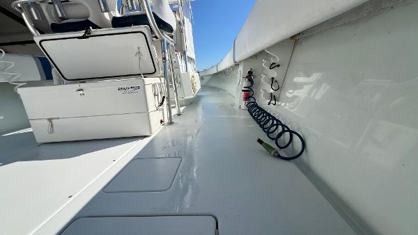 Slide: The Image of 2005 Contender 36 Open boat deck with storage and coiled hose. - 16