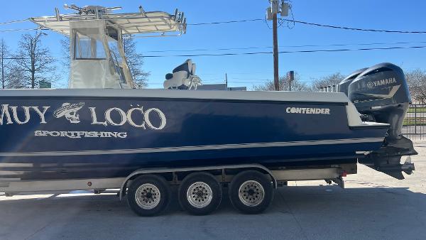 Slide: The Image of 2005 Contender 36 Open sportfishing boat on a trailer with Yamaha outboard engines. - 6