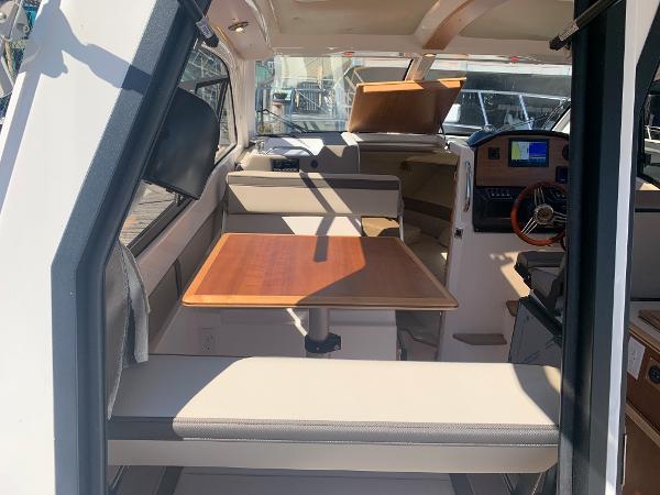 Slide: The Image of Interior of 2022 Cutwater C-24 Coupe with dining table and navigation console. - 10
