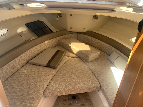 Slide: The Image of 2022 Cutwater C-24 Coupe interior cabin with beige upholstery and cushions. - 12