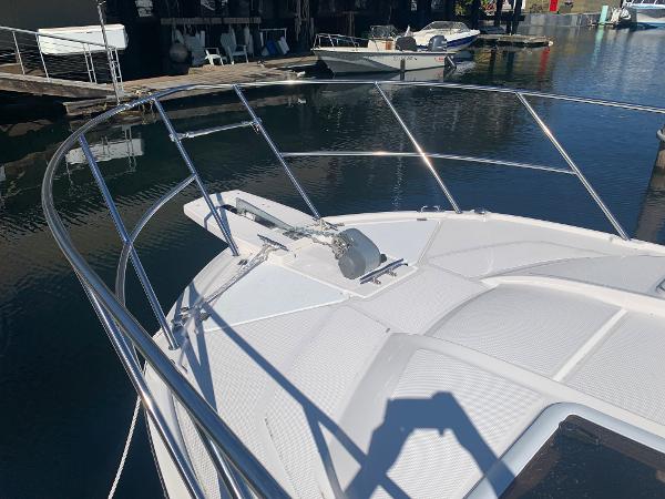 Slide: The Image of 2022 Cutwater C-24 Coupe boat bow with stainless steel railings in marina. - 18