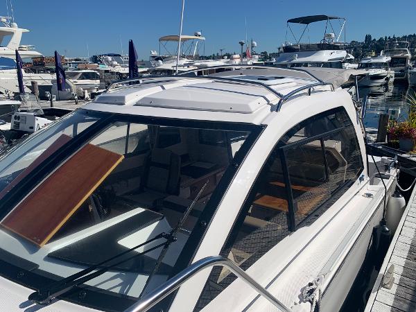 Slide: The Image of 2022 Cutwater C-24 Coupe docked at a marina with other boats. - 19