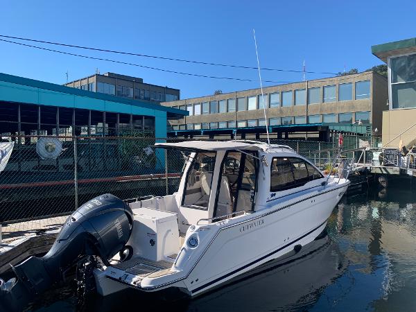 Slide: The Image of 2022 Cutwater C-24 Coupe boat docked in a marina. - 20