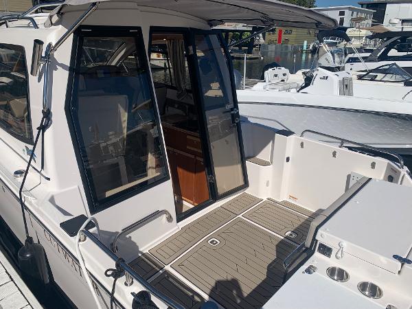 Slide: The Image of 2022 Cutwater C-24 Coupe boat with open cockpit and docked at marina. - 3