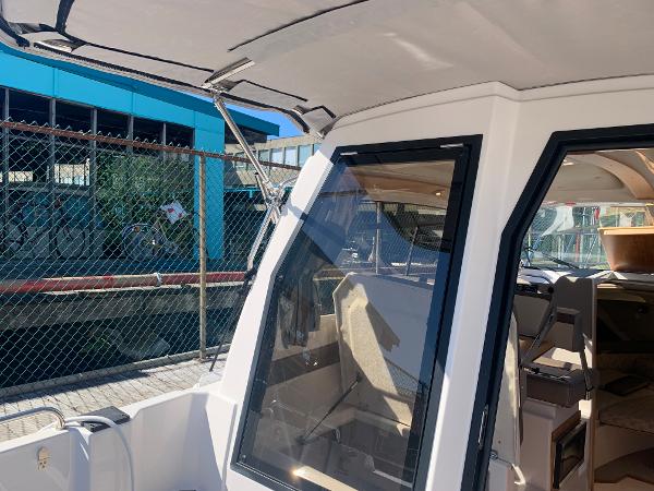 Slide: The Image of 2022 Cutwater C-24 Coupe boat docked, showcasing interior and exterior design. - 6