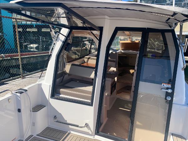 Slide: The Image of 2022 Cutwater C-24 Coupe boat interior with open door and seating area. - 7