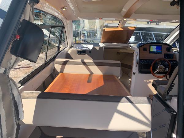 Slide: The Image of Interior of 2022 Cutwater C-24 Coupe boat with dining table and navigation console. - 9