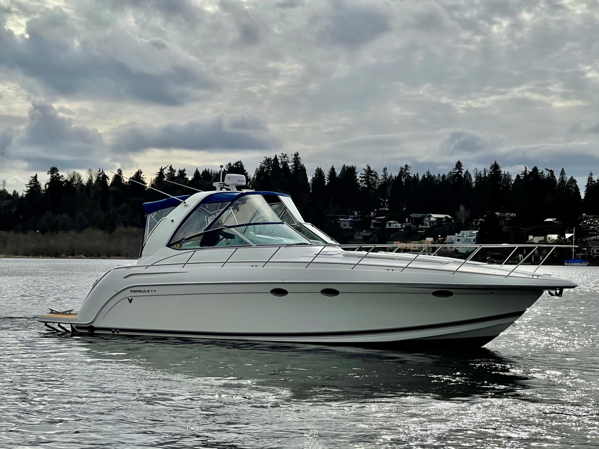 Slide: The Image of 2000 Formula 37 PC boat on a lake with a forested shoreline. - 0