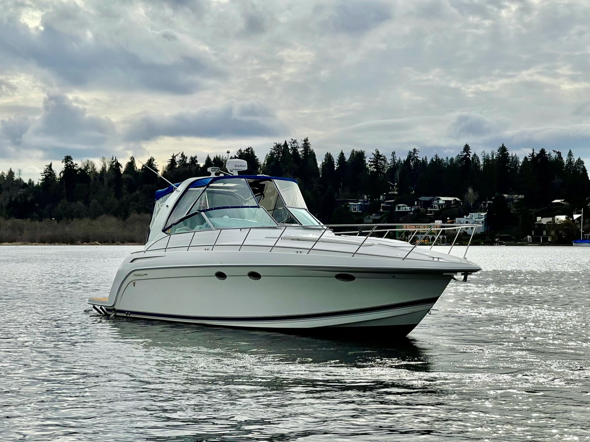 Slide: The Image of 2000 Formula 37 PC yacht on a calm lake with a forested shoreline. - 1