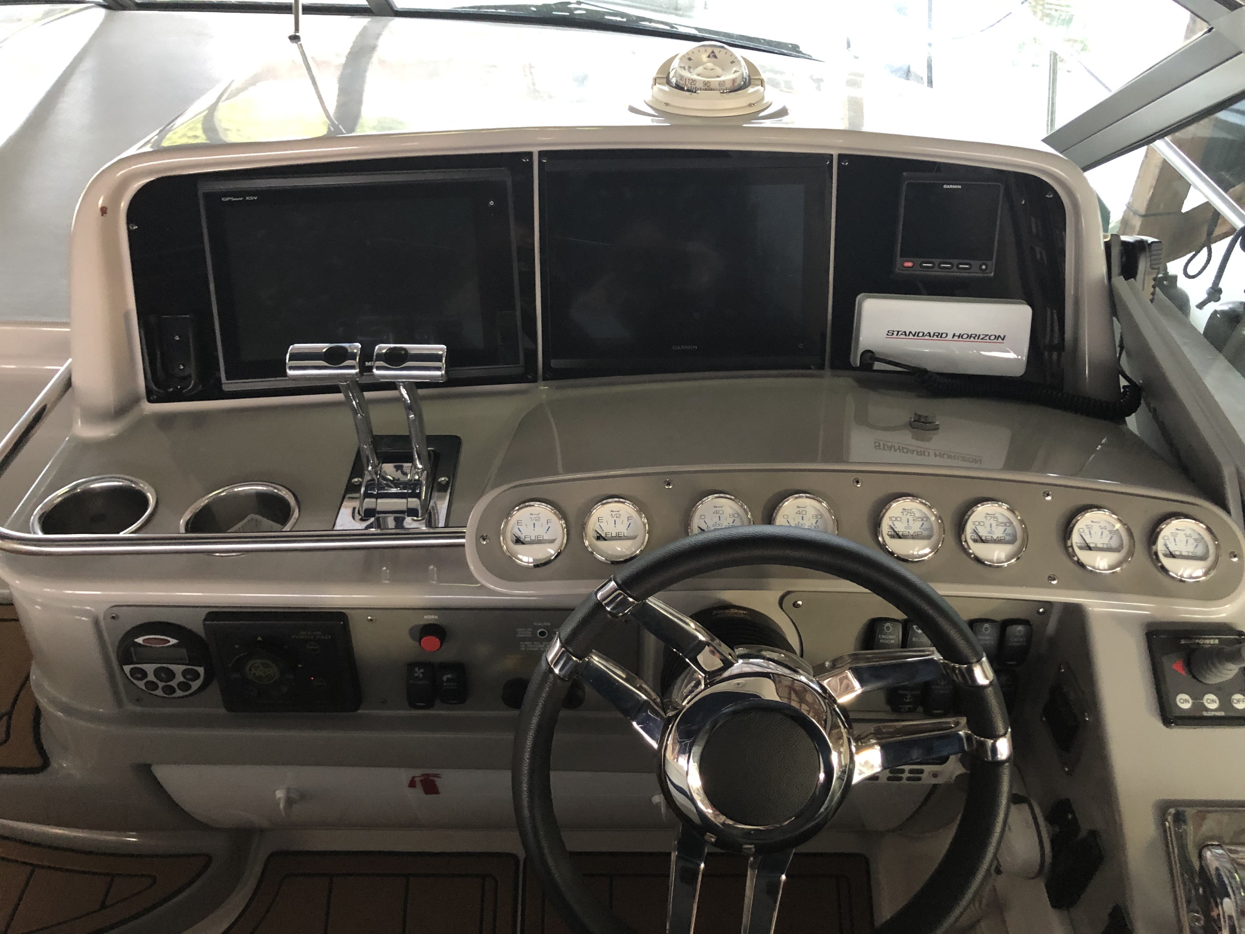 Slide: The Image of 2000 Formula 37 PC boat helm with steering wheel, gauges, and navigation equipment. - 10
