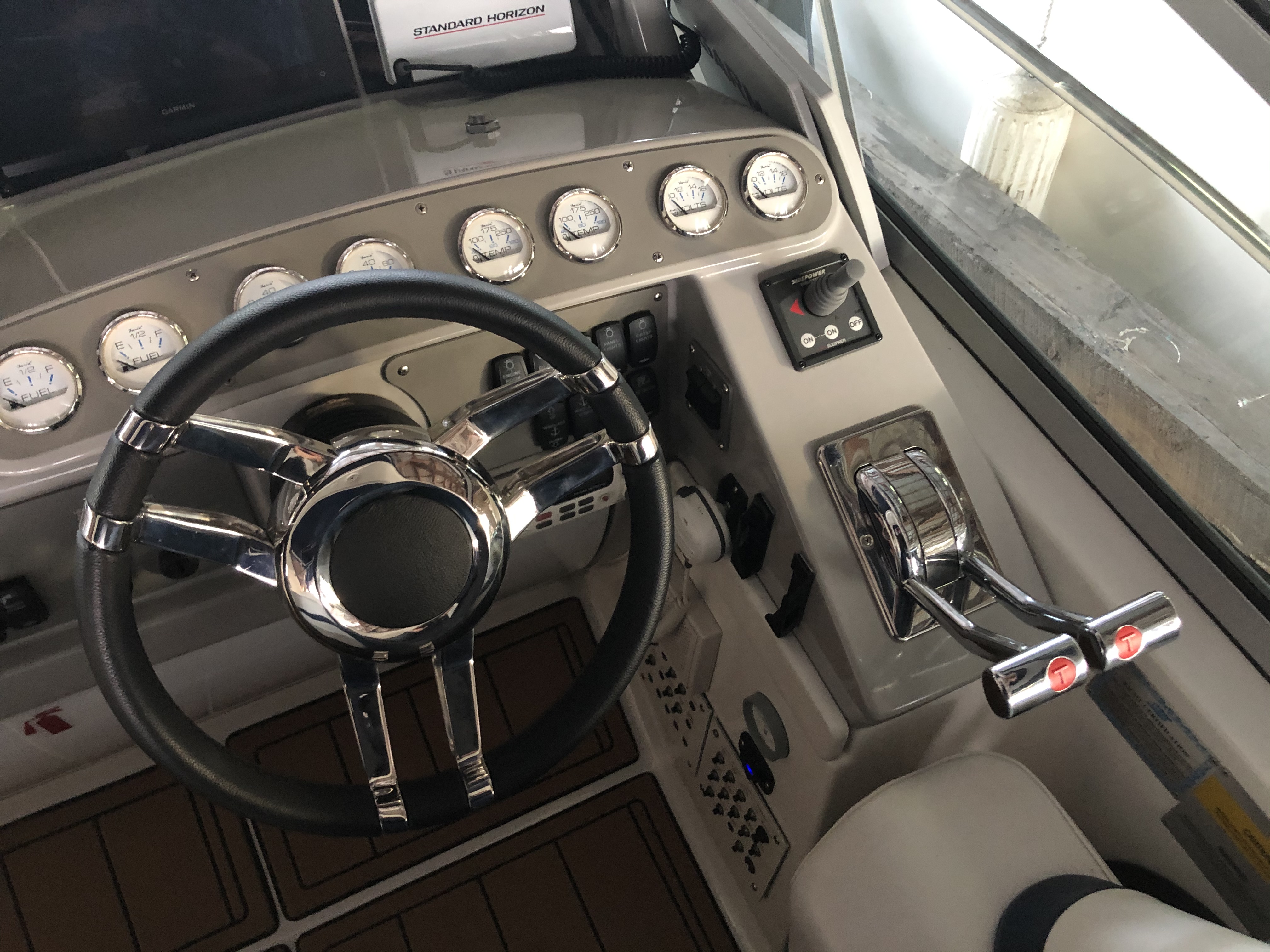 Slide: The Image of Steering wheel and controls of a 2000 Formula 37 PC boat. - 11