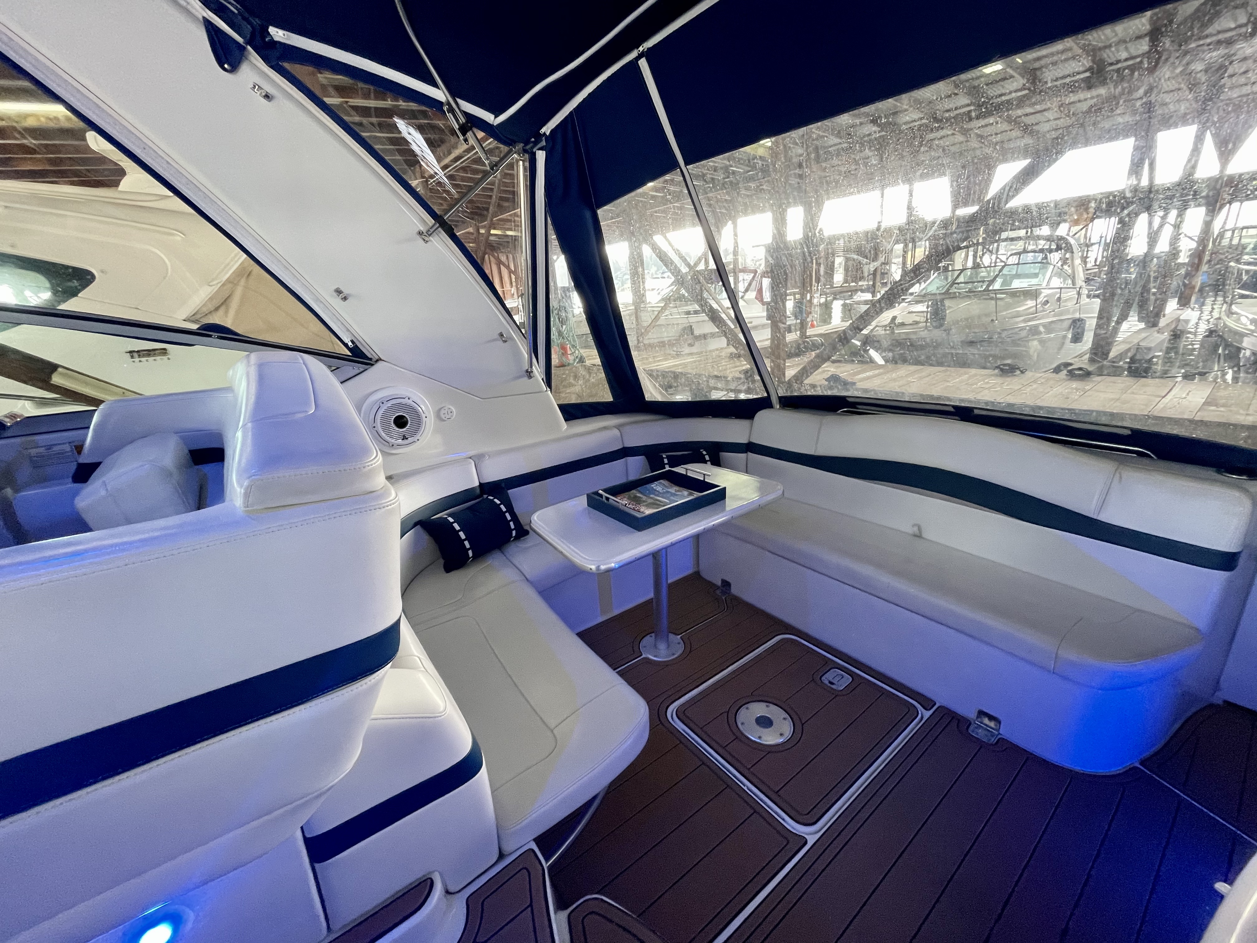 Slide: The Image of Interior of a 2000 Formula 37 PC yacht with white seating and a small table. - 12