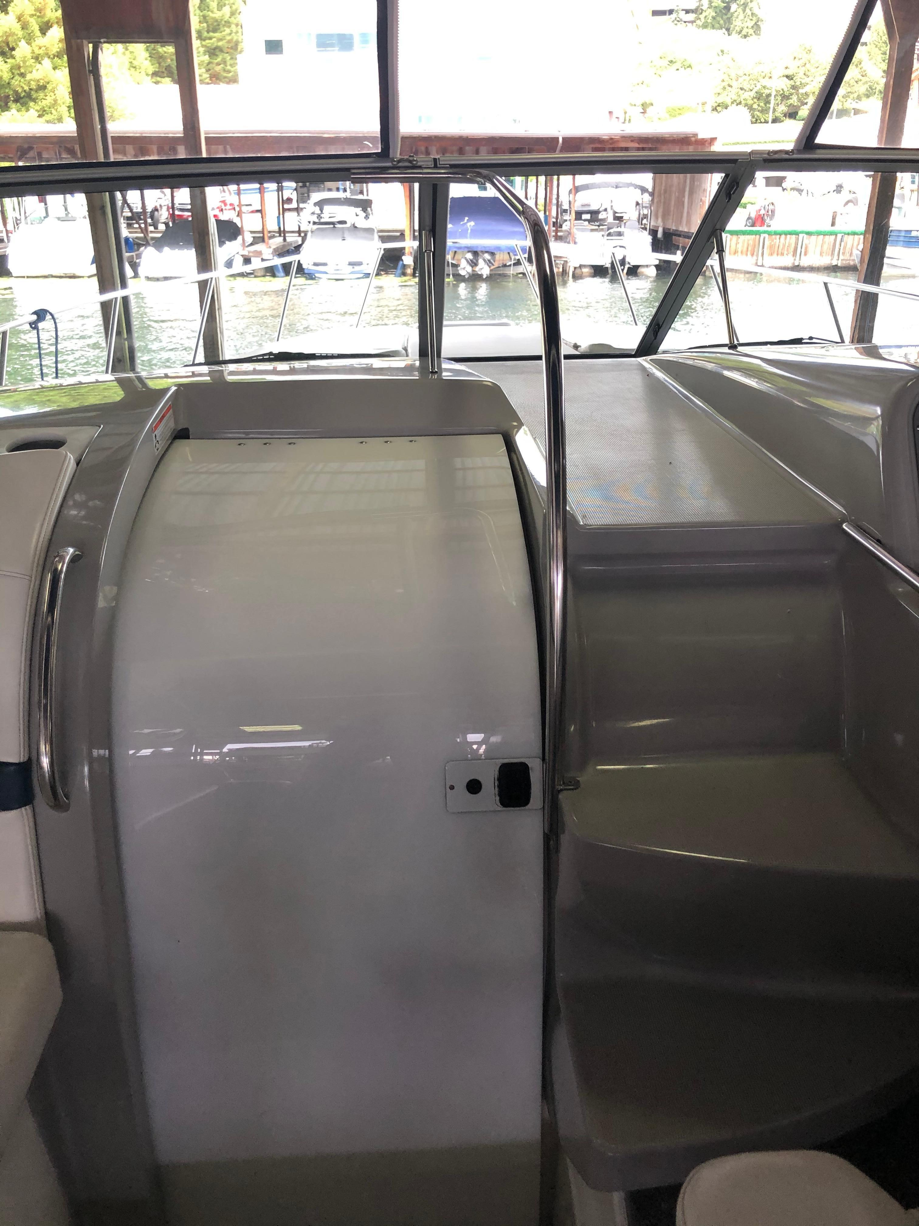 Slide: The Image of Interior view of a 2000 Formula 37 PC yacht with docked boats in the background. - 17