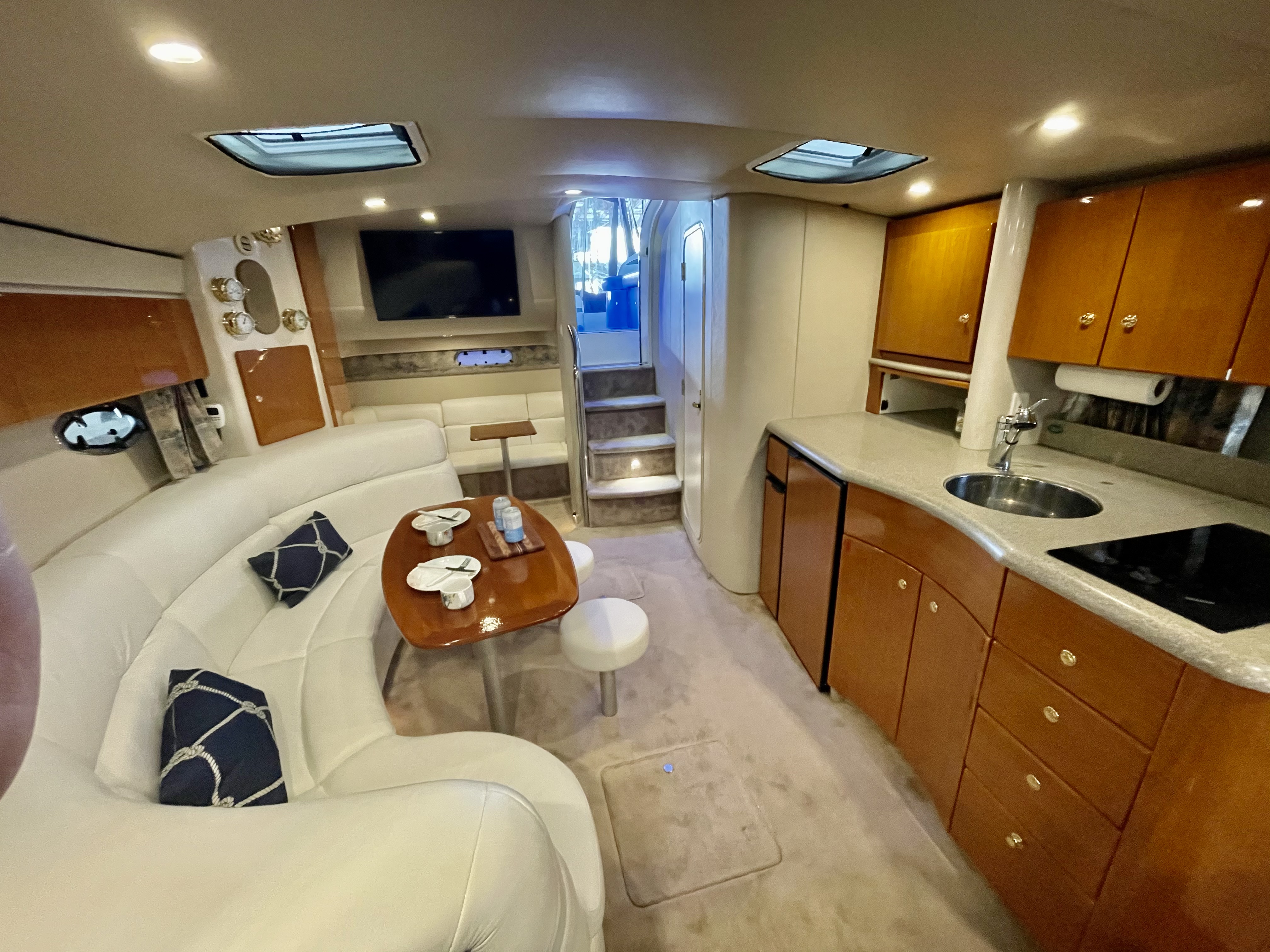 Slide: The Image of Interior of a 2000 Formula 37 PC yacht with modern amenities and cozy seating. - 21