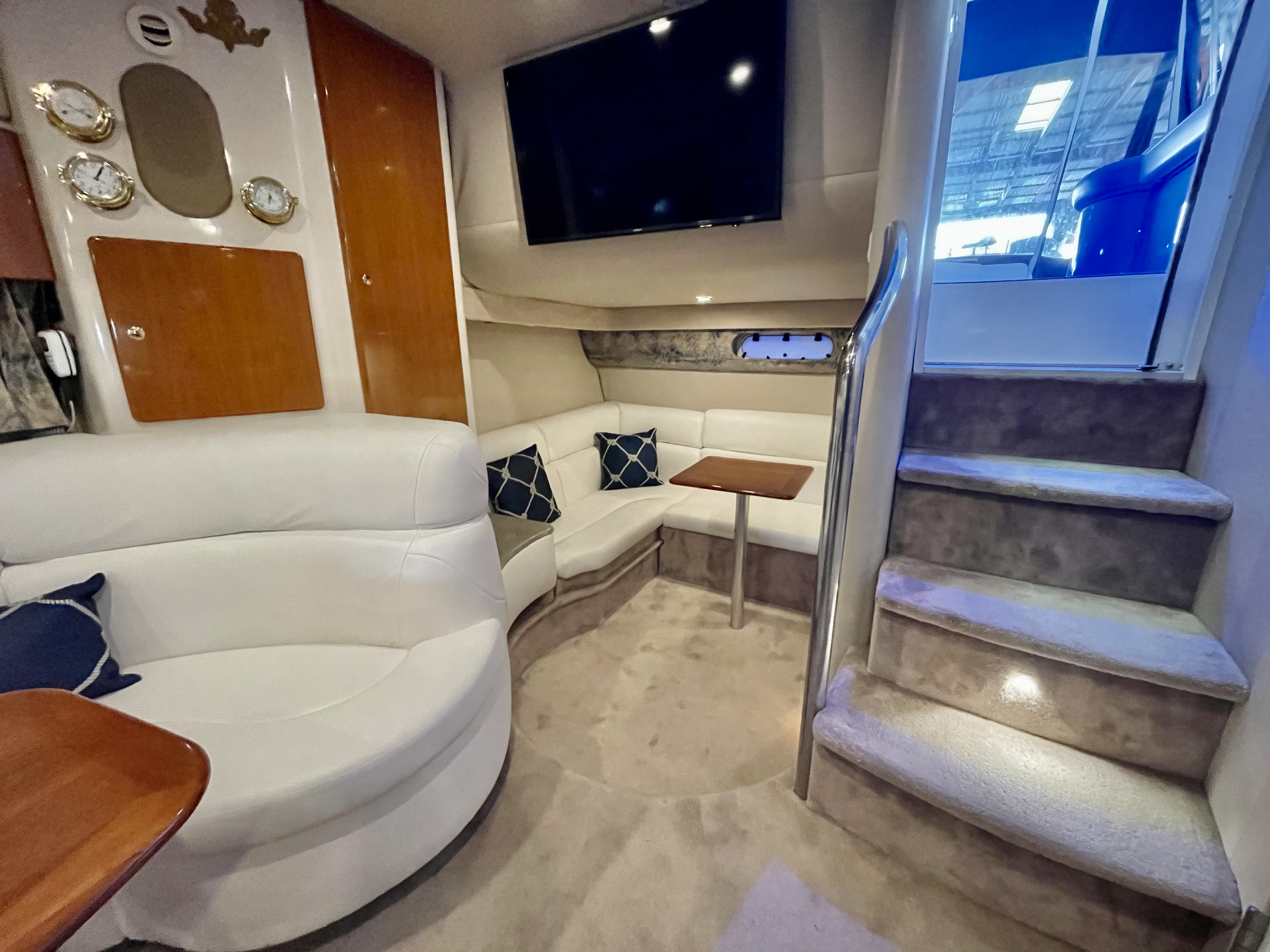Slide: The Image of Interior of 2000 Formula 37 PC yacht with white seating, wooden cabinets, and stairs. - 22