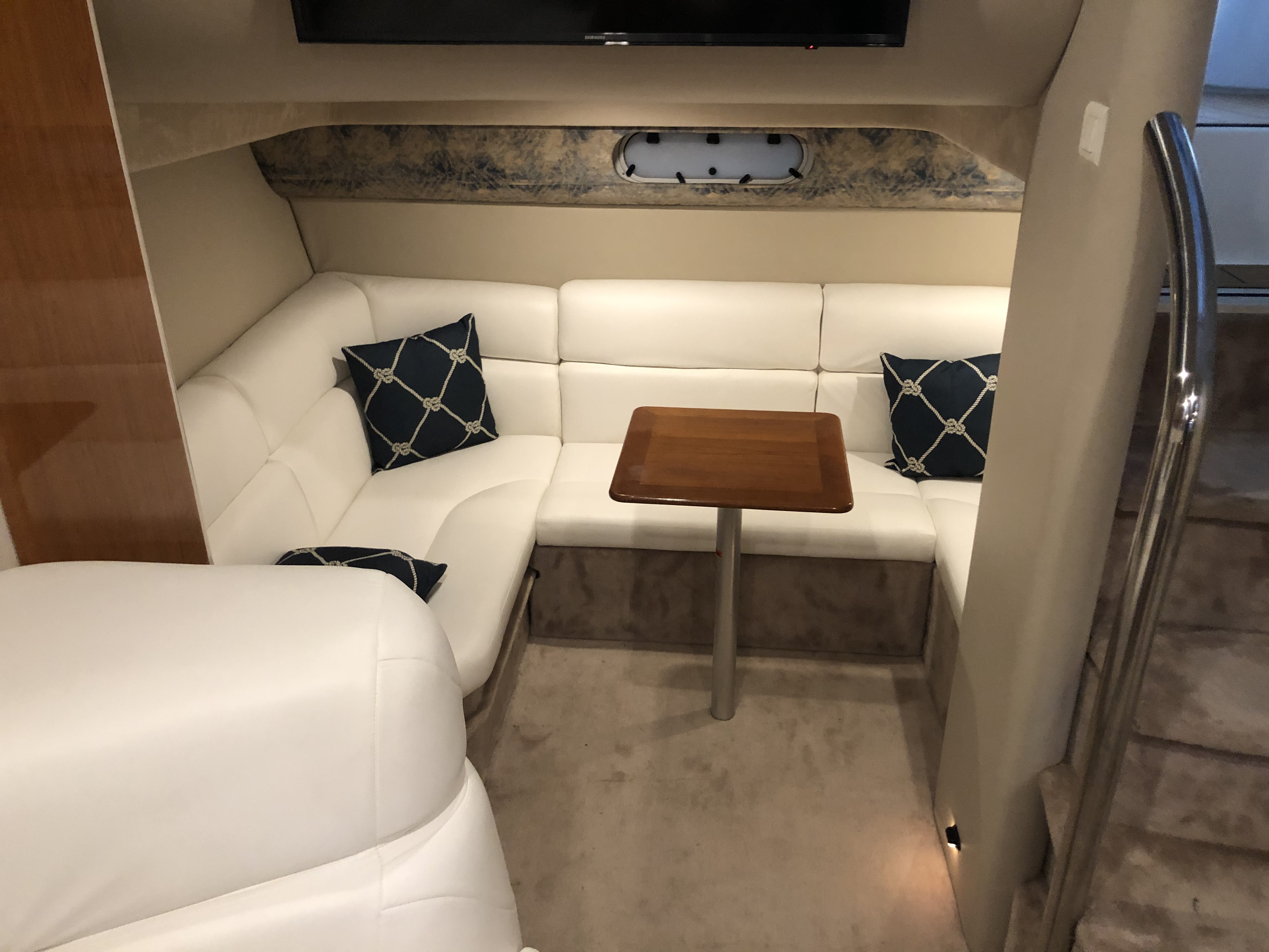 Slide: The Image of Interior of a 2000 Formula 37 PC yacht with white leather seating and wooden table. - 23