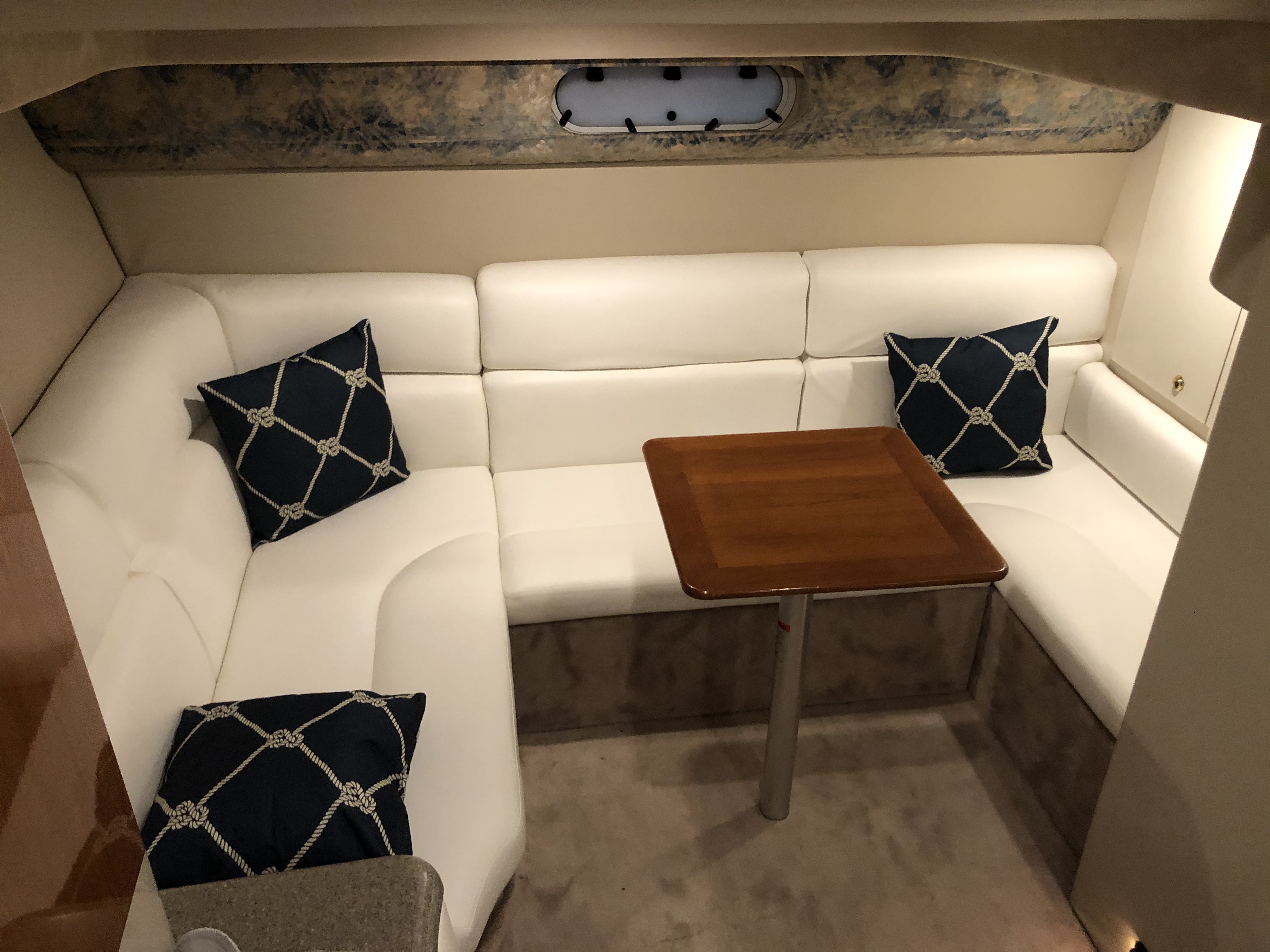 Slide: The Image of Interior of a 2000 Formula 37 PC yacht with white seating and wooden table. - 24