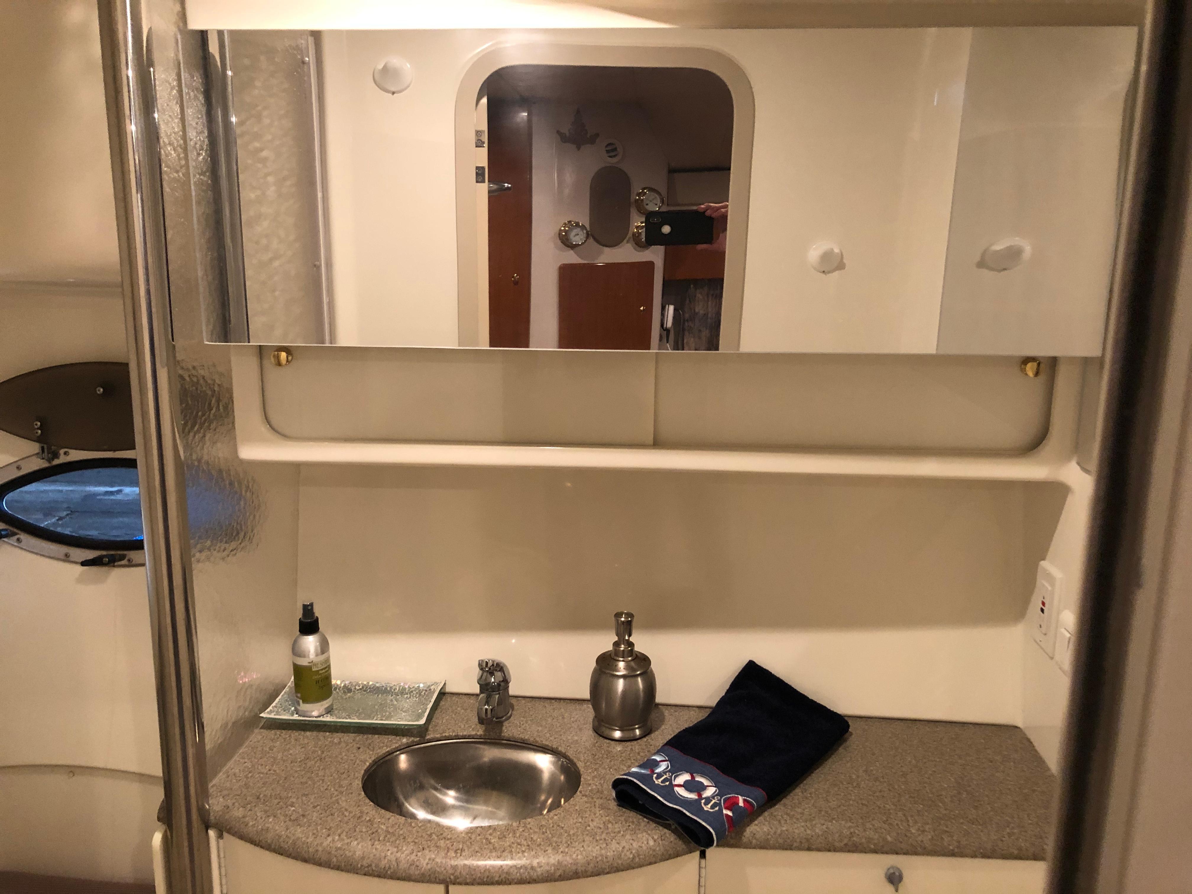 Slide: The Image of Bathroom vanity area in a 2000 Formula 37 PC yacht with sink and mirror. - 29