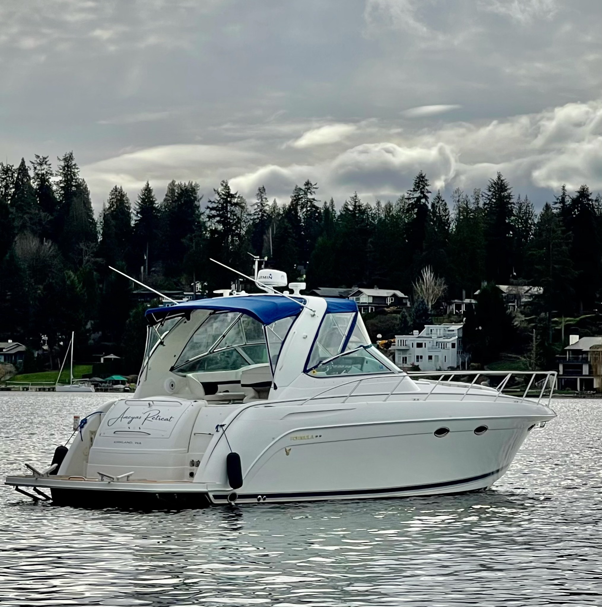 Slide: The Image of 2000 Formula 37 PC yacht on a serene lake with forested shoreline. - 3